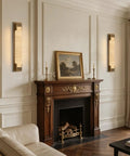 Elegant LuminaBrass Alabaster Wall Sconce on a wall, solid brass lighting complementing vintage decor.