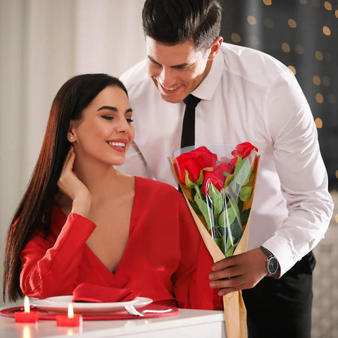 Man presenting bouquet in 50 Pack Flower Wrapping Bags For Bouquets, Kraft Paper Floral Packing Sleeves, romantic setting