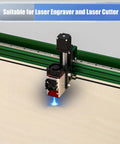 Side view of laser engraver head cutting wood sheet on green track; blue laser glow.