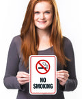 Straight Up Heavy Duty Aluminum No Smoking Sign For Your Company Setup Keep The Shop Floor Smoke Free Rust Resistant Indoor Outdoor Metal Wall Plate Super Durable held by a woman.