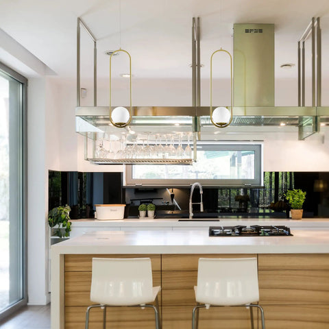 Integrated LED Pendant Light In Antique Brass With White Glass Shade in modern kitchen setting, two fixtures above island.