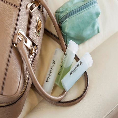 Compact White Label Maker Bundle With Four Tape Rolls For Hassle Free Home And Office Storage Featuring Dead Simple One Touch Keys Quick Print Templates And No Sweat Setup Design For Everyday Clutter Solutions Just Great resting beside a tan handbag and green pouch.