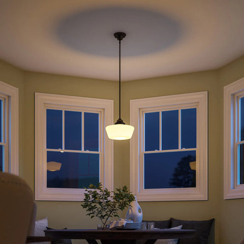 Cambridge 1 Light Pendant in Blackened Oil Rubbed Bronze with White Glass Shade illuminating dining area at dusk.