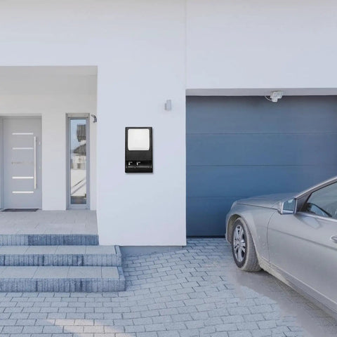 Wall Mount Garage Door Control Panel Switch For Plug And Play Opener Setup on exterior garage wall beside grey door and car
