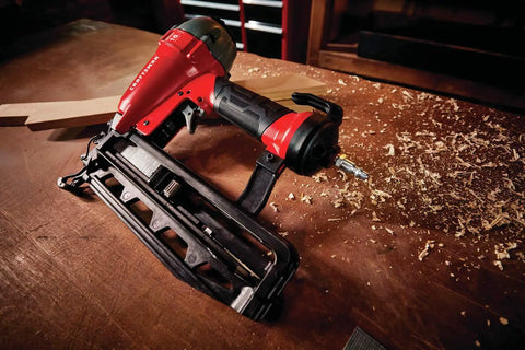 Finish Nailer 16 Gauge Pneumatic With Oil Free Motor on wooden bench, showcasing tool free depth of drive adjustment