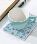 Solid Grip Square Ceramic Drink Coasters With Non Slip Cork Base Waterproof Design To Keep Surfaces Fresh And Dry Real Deal Quality For Home Bars And Coffee Tables with coffee cup on patterned coaster.