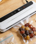 4 Piece Nichrome Heating Strip Replacement For Vacuum Sealer Machine 337mm Seal Element Bar With Even Heat Distribution For Food Packaging Bags And Shrink Film Sealing Upgrades Your Gear vacuum sealer with sealed food bag on wooden surface.