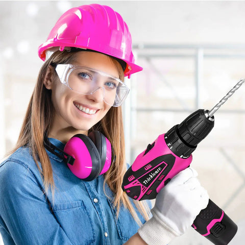 Woman in safety gear holding a pink drill from Pink Drill Set For Women 137 Piece Home Tool Kit With 12V Cordless Drill Charger Battery