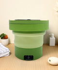 Portable Mini Washing Machine 6 Liter Foldable Compact Cleaner in green with lightweight design for travel on wooden table.