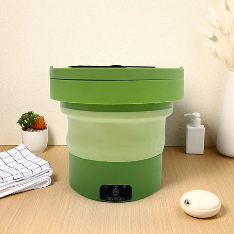 Portable Mini Washing Machine 6 Liter Foldable Compact Cleaner in green with lightweight design for travel on wooden table.