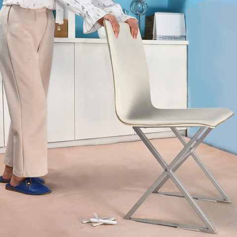 Person using 16 Piece Self Stick Furniture Sliders For Carpet Floors on a chair leg for easy movement across carpet.