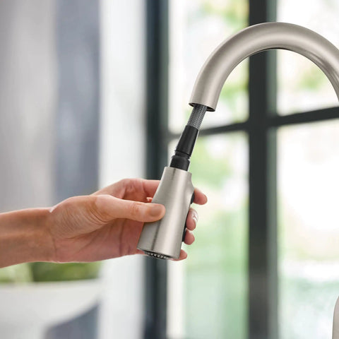 Top Shelf Stainless Steel Pull Down Kitchen Faucet Featuring One Handle High Arc Design With Fast Wash Power Boost And Smudge Resistant Matte Finish For Quick Cleanup And No Hassle Setup Plus Smooth Retractable Spray Hose Operation in hand.