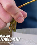 Hand connecting mounting attachment on 15,000 BTU Single Tank Top Portable Propane Radiant Heater with 20 lb tank visible
