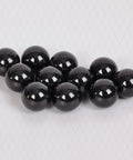 Fifty Piece Silicon Nitride Si3N4 Ceramic Balls Three Sixteenth Inch G5 Precision Bearing Spheres on background.