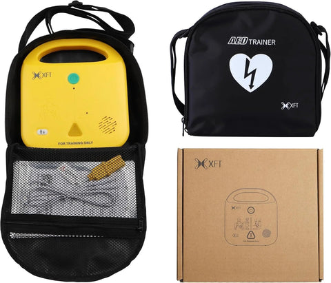 Front view of XFT AED trainer set: yellow trainer in black backpack case with mesh pocket and cardboard box.