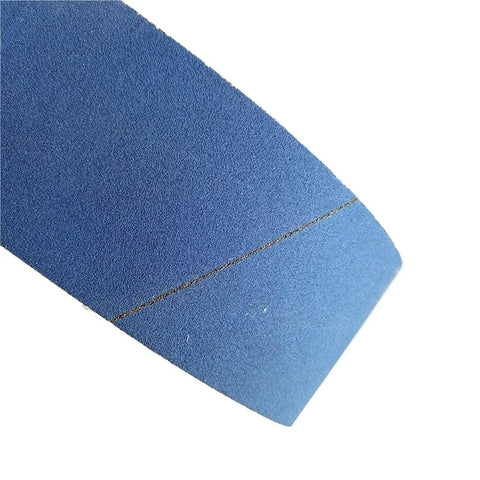 Pro Grade Calcined Aluminum Oxide Sanding Belts Set Of Five Four By Thirty Six Inch Assorted Grit Pack close-up of blue belt surface for heavy metal grinding.