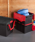 Haul Heavy Loads With Ease Using These Tough As Nails 12 Gallon Storage Totes With Secure Lids For Garage Organization Stackable Heavy Duty Crates Featuring Tie Down Grommets In A Rock Solid 12 Pack Bundle in black and red, filled with blue gear.
