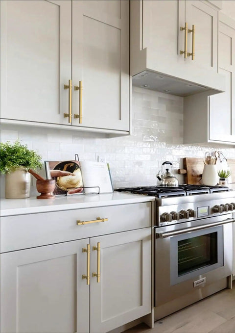 Top Tier Brushed Gold Cabinet Pulls 10 Pack 5 Inch Center To Center on modern kitchen cabinets with light gray finish.