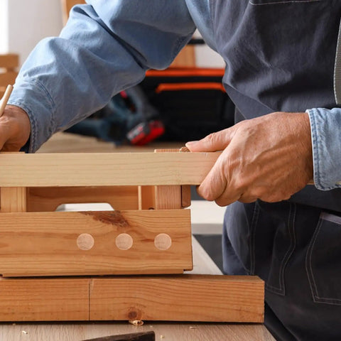 Person installing wooden furniture hole plugs for table and chair legs, round hardwood screw hole covers with snap fit easy install.