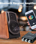 Bluetooth 5.0 Amplifier Board with Bass and Treble Control next to wooden speaker and smartphone in use