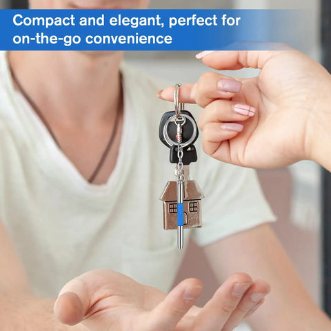 Person handing a Handy 3-In-1 Eyeglass Repair Kit With Keychain Screwdrivers, stainless steel mini toolset, featuring house charm.