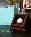 Hole In One Golf Ball Display Case With Wood Frame And Glass Lid Handcrafted Keepsake Box on table next to blue box