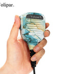 Hand holding a Waterproof Speaker Microphone Workhorse For Baofeng UV 5R UV 82 BF F8HP UV 82HP UV 82L And Kenwood in serene scenery
