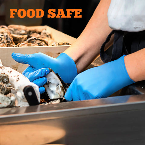 Blue nitrile gloves being worn by a worker handling seafood at a stainless prep station