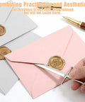 Hand using Vintage Sword Style Letter Opener For Envelopes And Mail With Slick Precision Slitter on sealed pink envelope