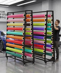 Heavy Duty Garage Mobile Vinyl Wrap Organizer Rack Featuring Adjustable Multi Tier Metal Frame And Smooth Rolling Lockable Casters, storing colorful vinyl rolls.