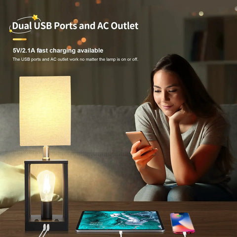 Two Bulb Farmhouse Bedside Lamp With USB Ports And AC Outlet Cozy Beige Fabric Shade Table Light For Bedroom Living Room Bulbs Included Ideal For Reading And Relaxing next to woman charging phone