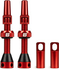 Red aluminum Presta tubeless valve stems (pair) with knurled collars and red caps (front view).