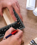 Badass 8X12 Inch Carpenter Square Pro Builder Heavy Duty Carbon Steel Framing Tool used for marking wood on a workbench.