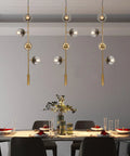 Lit Four Light Smoky Gray Glass Globe Pendant Light With Adjustable Cord And Gold Accents For Kitchen Island Bar Modern LED Chandelier