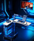Level Up Your Setup With One Touch Electric Height Adjustable Mobile Gaming Desk Featuring Floating Shelf Dedicated CPU Stand Three Posture Modes And Built In Power Strip in modern gaming setup with blue lighting.