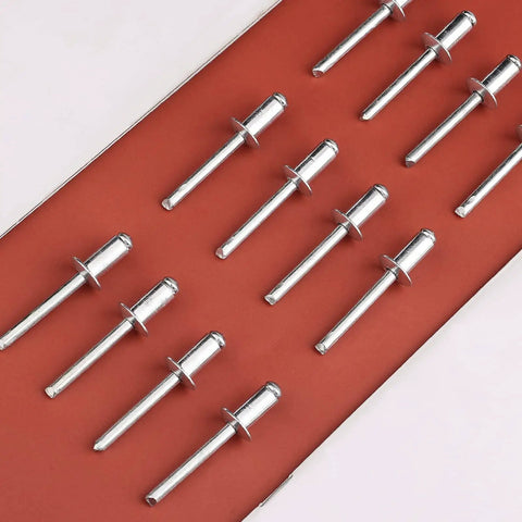 Aluminum Blind Rivets Set 1/4 By 1/2 Inch Large Flange Pull Rivets Self Plugging Pop Rivets Kit, arranged in rows on a red background