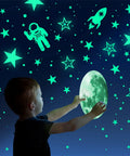Child interacts with Glow In The Dark Stars And Planets Ceiling Wall Decor Kit With Rockets And Astronauts for a galaxy-themed room.