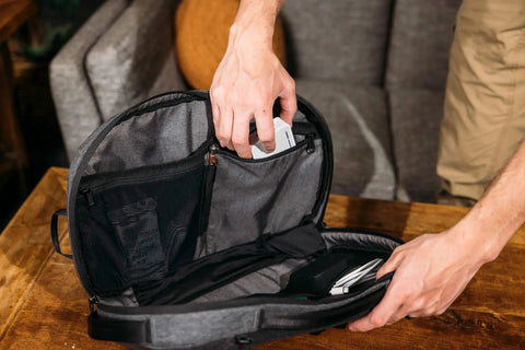 Person demonstrating anti-theft pocket system of Lightweight 6L Crossbody Sling Bag For Travel And Everyday Carry on table