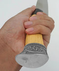 Hand holding a knife with Two Piece Knife Bolsters And Finger Guard Kit for DIY knife making and safe handle construction.