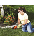 Person using Cordless Shrub Trimmer And Grass Shear Combo, Lightweight Three Point Six Volt Lithium Battery, Easy Grip, Low Emission Yard Tool for edging