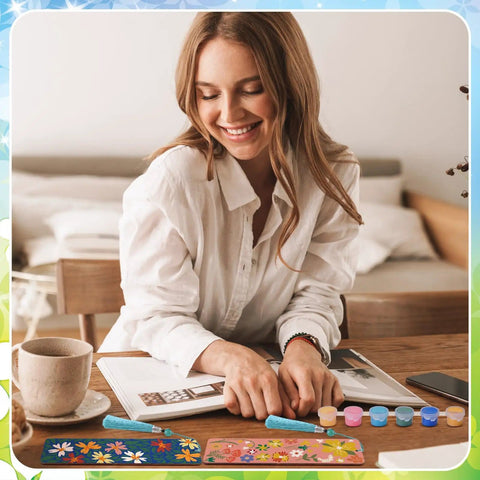 Woman painting Butterfly And Floral Bookmark Paint By Numbers Kit For Adults with 12 wooden bookmarks, 7x2 inches, on table.