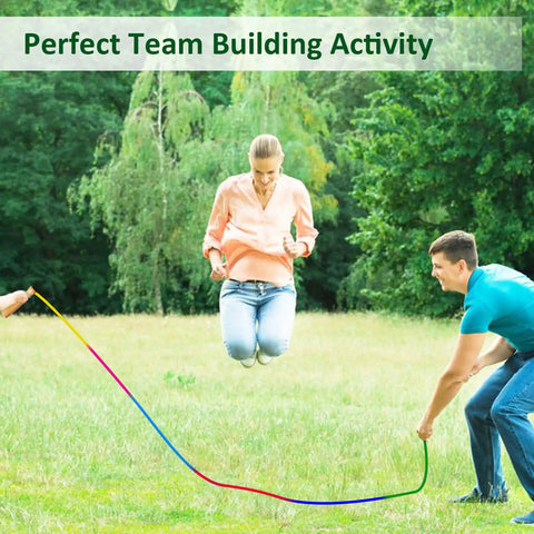 Adults playing with Rainbow Double Dutch Jump Rope Set Two Pack 16 Foot Long Jump Rope For Kids And Adults With Wooden Handles Durable Tangle Free For Group Play And School Gyms Great For Outdoor Crew Fun in park.