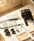 Universal EV Charger Retractable Cord Reel Keeps Your Garage Cables Fly And Secure While Delivering Smooth Wall Mount Retraction, tools and mounting hardware on a table.