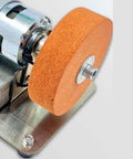 Close-up of Compact Mini Belt Sander With High Power Motor And Adjustable Speed Options From 3000 To 6000 Rpm, showing sanding wheel.