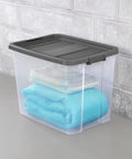 Heck Yeah 2 Pack 108 Quart Stackable Storage Containers With Deep Recessed Latch Lids clear plastic bin holding folded blankets.