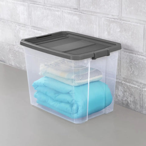 Heck Yeah 2 Pack 108 Quart Stackable Storage Containers With Deep Recessed Latch Lids clear plastic bin holding folded blankets.