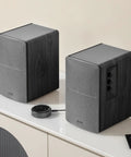 R1280T Powered Bookshelf Speakers For Studio Monitoring 2.0 Active Near Field Monitors with remote and EQ controls on table