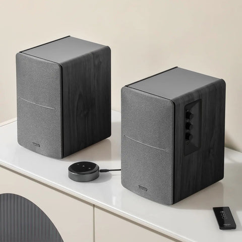 R1280T Powered Bookshelf Speakers For Studio Monitoring 2.0 Active Near Field Monitors with remote and EQ controls on table