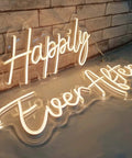 Two Piece Dope Happily Ever After LED Neon Light Sign Set Warm White With Dimmer 14.6x7.5 And 20.9x7.5 Inches on table