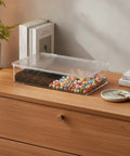 Clear Pet Storage Bin Kick Clutter To The Curb In Style Slick Transparent Plastic Organizer for colorful snacks on wooden surface.